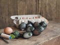 Easter eggs painted onion peel with a pattern of fresh herbs on a wooden ancient background. We color the eggs according to the