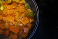 prepare soup with orange pumpkin cut into pieces Royalty Free Stock Photo