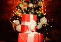 Prepare surprise gifts for family. Gift from Santa. Composition with gift boxes ribbon bow. Red wrapped gifts or