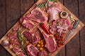 Assorted minced meat ingredients - rack of calf, ribeye, rack of lamb, with garlic, onions, red and yellow tomatoes, red pepper