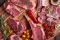 Assorted minced meat ingredients - rack of calf, ribeye, rack of lamb, with garlic, onions, red and yellow tomatoes, red pepper