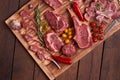 Assorted minced meat ingredients - rack of calf, ribeye, rack of lamb, with garlic, onions, red and yellow tomatoes, red pepper