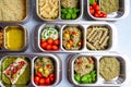 Prepared diet Lunches in lunch boxes: pasta, parmesan, lettuce, cherry tomatoes with basil.