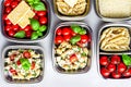 Prepared diet Lunches in lunch boxes: pasta, parmesan, lettuce, cherry tomatoes with basil.