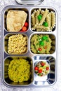 Prepared diet Lunches in lunch boxes: pasta, parmesan, lettuce, cherry tomatoes with basil.