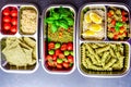 Prepared diet Lunches in lunch boxes: pasta, parmesan, lettuce, cherry tomatoes with basil.