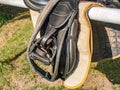 Prepared english saddle with stirrups. Dressage of horses club.