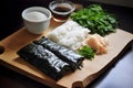 Prepared ingredients for cooking asian food rolls or sushi close up on wooden board. Selective focus. Asian food concept Royalty Free Stock Photo