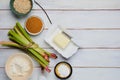 Prepared ingredients for cooking rhubarb crumble on a light wooden background. Rhubarb recipes