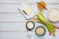 Prepared ingredients for cooking rhubarb crumble on a light wooden background. Rhubarb recipes
