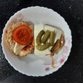 Prepared ingredients for a homemade bun with a cutlet on table