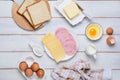 Prepared ingredients for making a hot croque madame sandwich on a white wooden background. Recipes for sandwiches, hot breakfasts Royalty Free Stock Photo