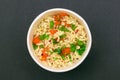 Prepared Instant Noodles with Carrot and Greens on Black Background Royalty Free Stock Photo