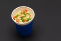 Prepared Instant Noodles with Carrot and Greens in Blue Cup Royalty Free Stock Photo