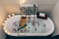 Spa bath with flowers, candles and tray Royalty Free Stock Photo