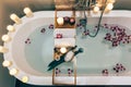 Spa bath with flowers, candles and tray Royalty Free Stock Photo