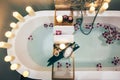 Spa bath with flowers, candles and tray Royalty Free Stock Photo