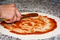 Prepared pizza dough with tomato sauce. Royalty Free Stock Photo