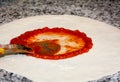 Prepared pizza dough with tomato sauce Royalty Free Stock Photo