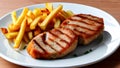 Prepared plate of grilled steaks and french fries Royalty Free Stock Photo