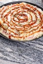 Prepared raw pizza with mushrooms cheese ham and ketchup on the grey granite table with copy space Royalty Free Stock Photo