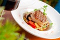 Prepared veal medallion with vegetables and sauce on plate Royalty Free Stock Photo