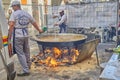 Prepares a delicious paella in a traditional large pan on the street during Las Fallas festival