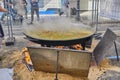 Prepares a delicious paella in a traditional large pan on the street during Las Fallas festival