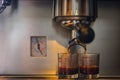 Prepares espresso in his coffee shop; close-up. Royalty Free Stock Photo