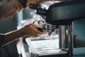 Prepares espresso pouring from coffee machine in coffee shop at cafe Royalty Free Stock Photo