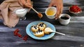 Prepares sandwiches with cream cheese ricotta, blueberries and honey on the whole grain bread bruschetta. Close up Royalty Free Stock Photo