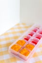 Preparing baby food, homemade. Healthy boiled or steamed crinkle sliced fresh carrots  preparing to be made as an ice cube in ice Royalty Free Stock Photo