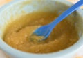 Preparing baby food, homemade.Top view of a bowl with mixed boiled apples in a blue bowl on a tablecloth. Healthy food kids