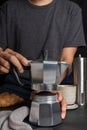 Preparing a barista using Italian moka pot coffee. making hot coffee with Croissant bread and equipment, percolator tool brewing Royalty Free Stock Photo