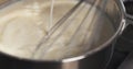 Preparing bechamel sauce milk pour Royalty Free Stock Photo