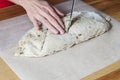 Preparing bread: female hands cutting bread dough Royalty Free Stock Photo