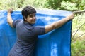 Preparing campsite with tarp