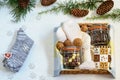 Preparing care package, seasonal gift box with coffee, chocolate, warm socks, walnuts. Personalized handmade gift box for