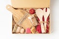 Preparing care package, seasonal gift box with plastic free, zero waste kitchen utensils.