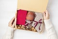 Preparing care package with warm socks, book, coffee cup, aroma spices