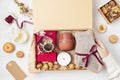 Preparing care package with warm socks, book, coffee cup, aroma spices