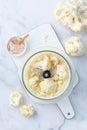 Preparing cauliflower rice in a food processor, cauliflower in a blender