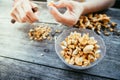 Farm holidays: Woman is preparing delicious chanterelle mushrooms on an old rustic wooden table