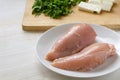 Preparing chicken breast fillet, lean poultry meat, feta cheese