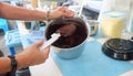 Preparing chocolate sauce in pot, liquid chocolate in a pot and stir with white spatula Royalty Free Stock Photo