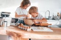 Preparing Christmas cookies. Little boy and girl on the kitchen Royalty Free Stock Photo