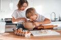 Preparing Christmas cookies. Little boy and girl on the kitchen Royalty Free Stock Photo