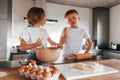 Preparing Christmas cookies. Little boy and girl on the kitchen Royalty Free Stock Photo