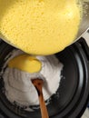 Preparing coconut flan mixing ingredients