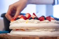 Preparing pavlova cake at home female hands